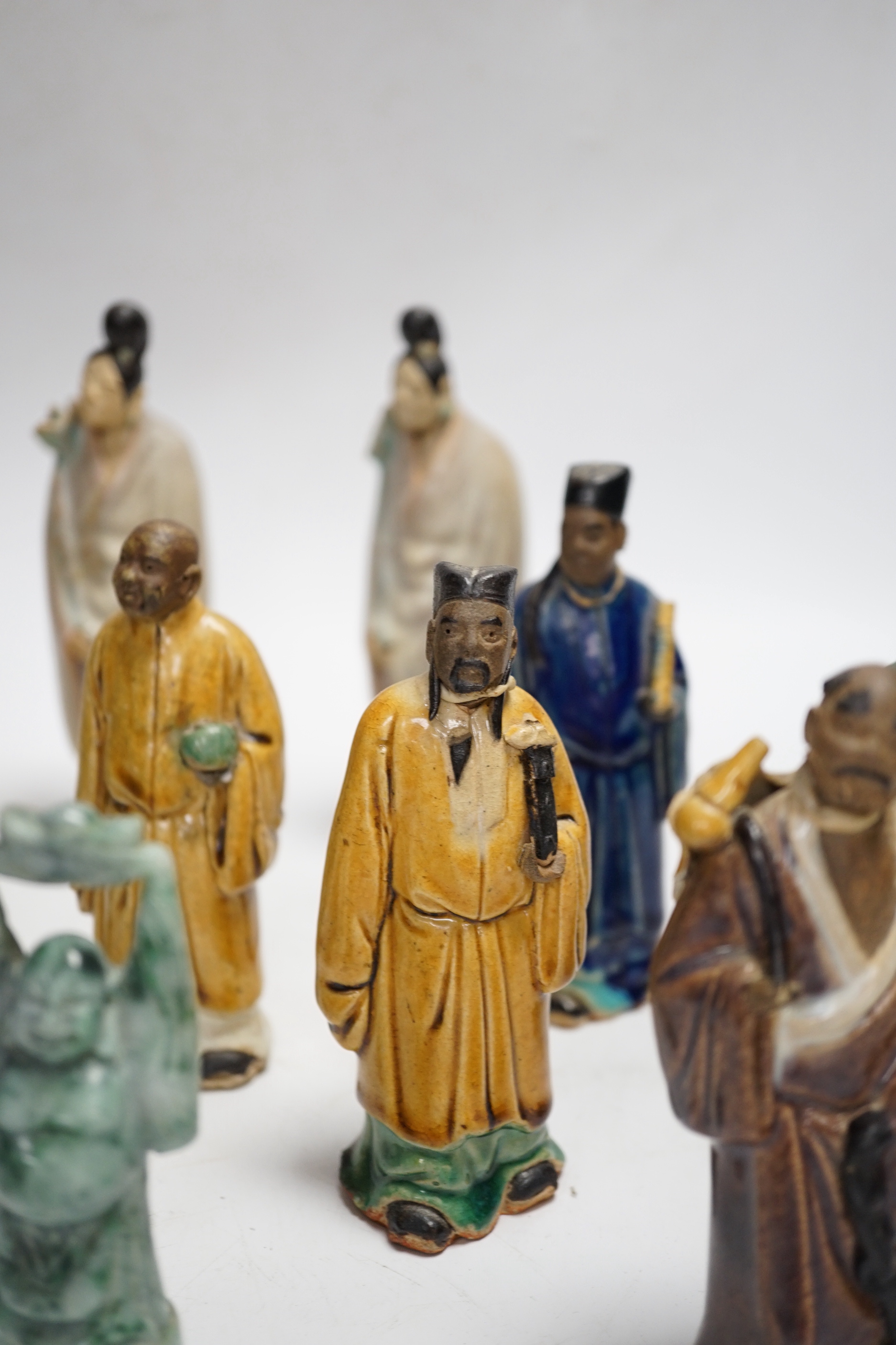 Fifteen Chinese Shiwan-type glazed pottery figures and carved stone figures, early 20th century, tallest 15cm